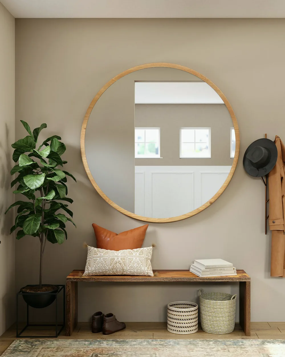 Entrée d’appartement avec miroir rond, banc et plante